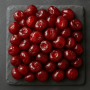 Candied bigarreau cherries presented on premium slate, top view, professional kitchen