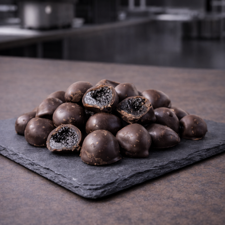 Candied bigarreau cherries coated in chocolate on slate
