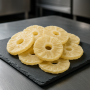 dehydrated pineapple slices on slate board in modern kitchen