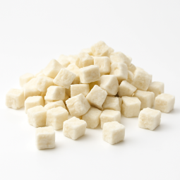 Dried coconut cubes on white background with soft natural shadows