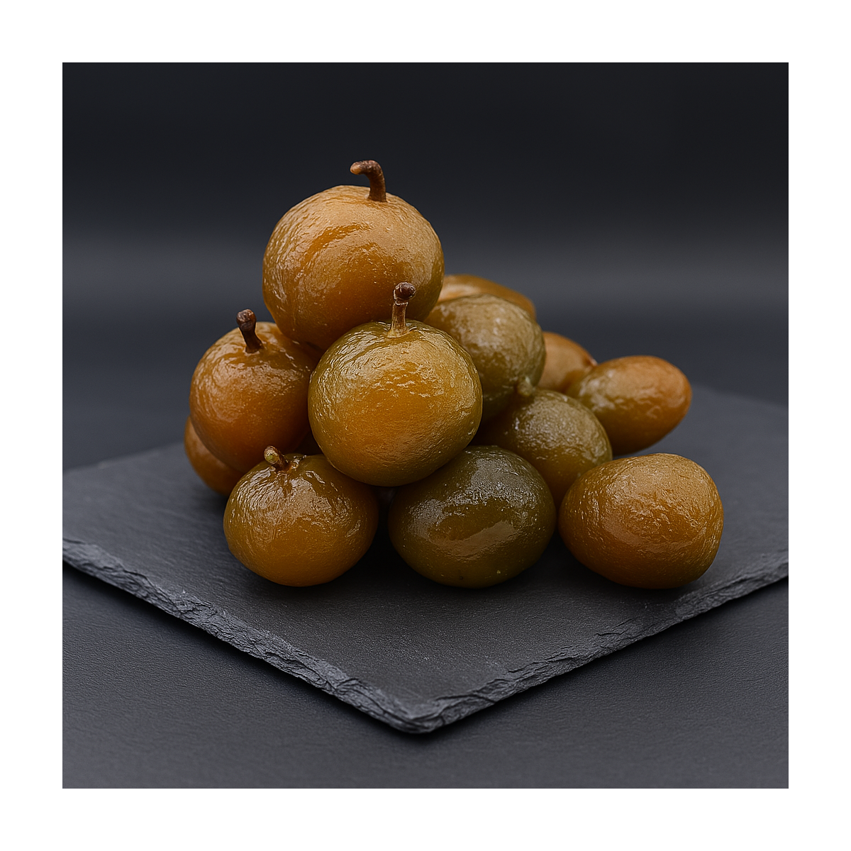 Artisanal glazed prunes from Provence arranged on a premium slate board, natural shine and texture preserved.