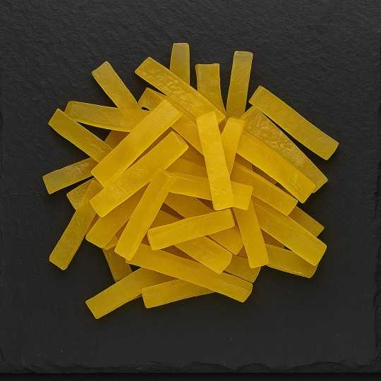 Candied ginger slices on a slate board, artisanal product from Provence.