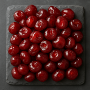 Glossy candied cherries on slate background, authentic Provence style