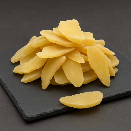 dried ginger slices on dark slate background