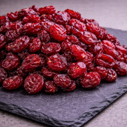 Dried cranberries presented on premium slate board, dried fruit product photo