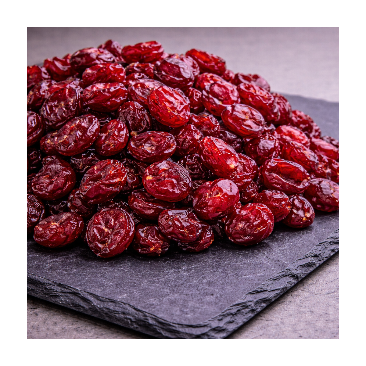 Dried cranberries presented on premium slate board, dried fruit product photo