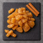 Sweet cinnamon dehydrated apples top view on premium slate